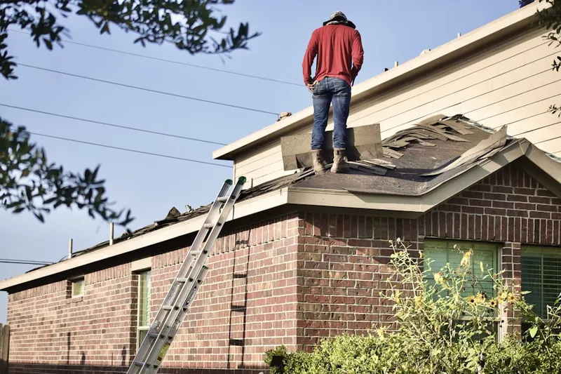 Professional roofer working on a residential roof in Original Village